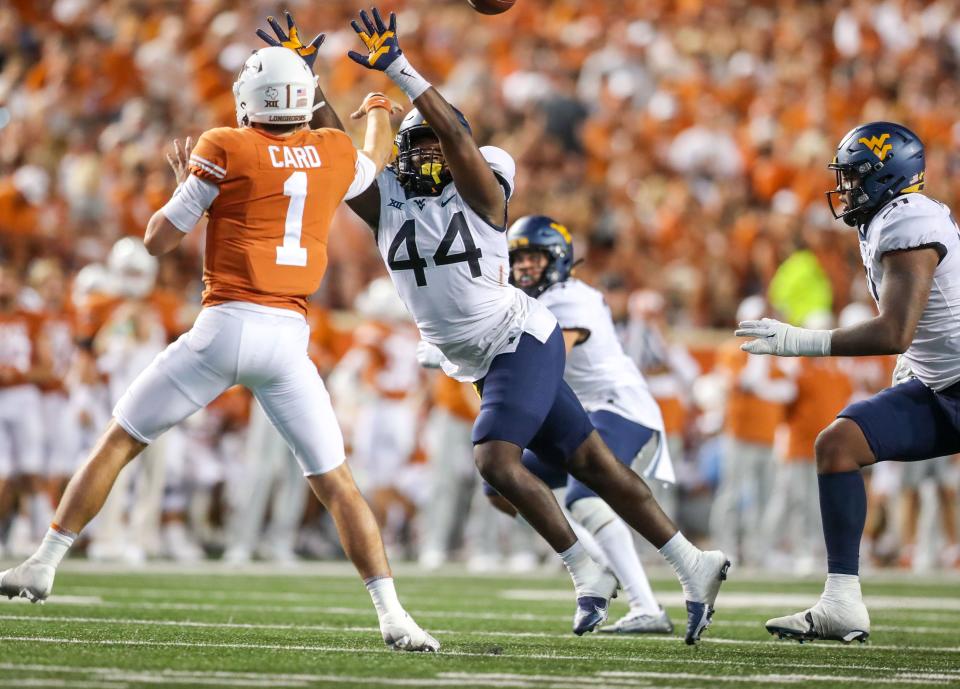 Oct 1, 2022; Austin, Texas, USA; West Virginia Mountaineers linebacker Lanell Carr (44) rushes Texas Longhorns quarterback Hudson Card (1) during a pass during the fourth quarter at Darrell K Royal-Texas Memorial Stadium.