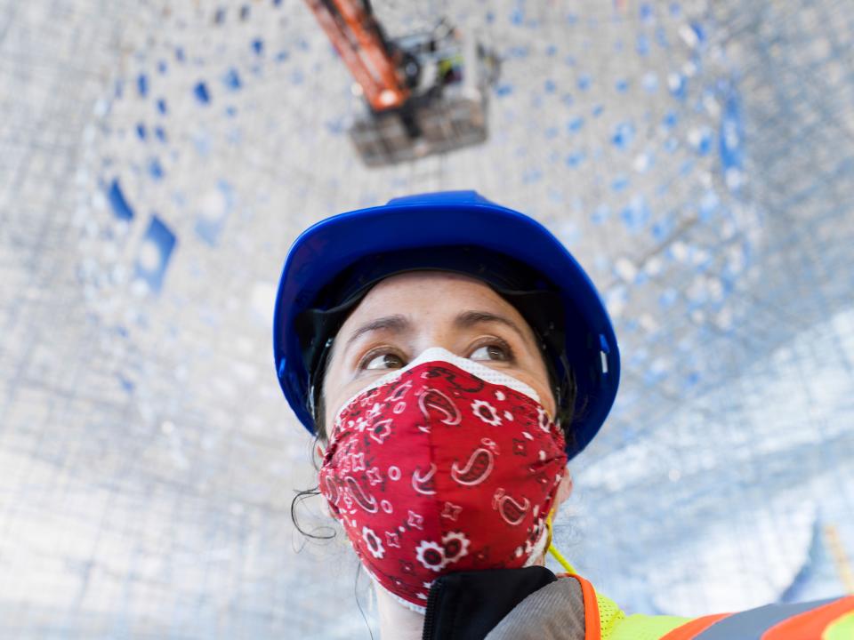 Sarah Sze, masked and on the job at LaGuardia during the installation of her sculpture this past May.