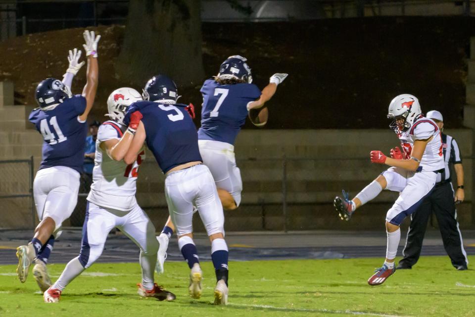 Redwood's Chase Dempsey blocks a punt into the end zone for the first score against Tulare Western in a non-league high school football game at Mineral King Bowl on September 8, 2023.