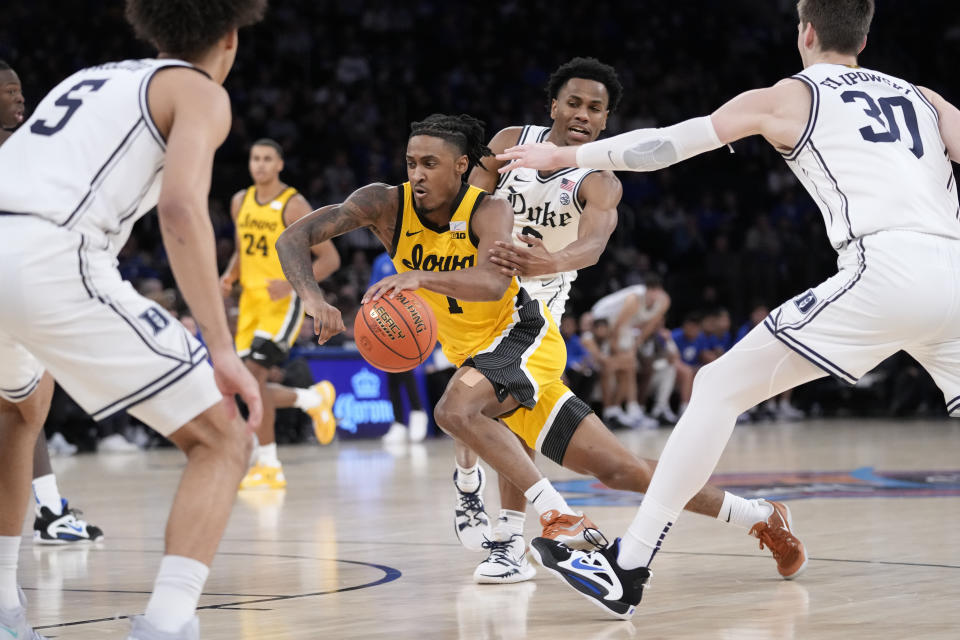 Iowa's Ahron Ulis (1) drives past Duke's Jeremy Roach (3) during the second half of an NCAA college basketball game in the Jimmy V Classic, Tuesday, Dec. 6, 2022, in New York. (AP Photo/John Minchillo)