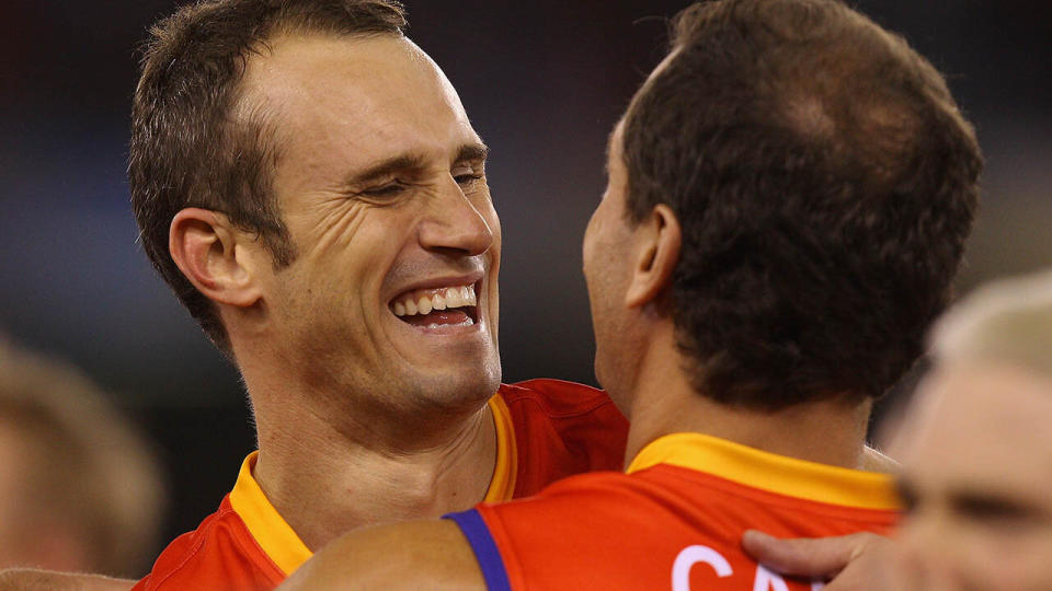 Ryan Fitzgerald and Wayne Carey during the E.J Whitten Legends Game in 2011.  (Photo by Quinn Rooney/Getty Images)