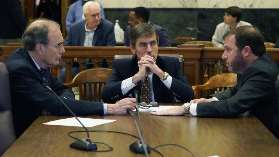 Republican Lt. Gov. Delbert Hosemann, left, Senate Appropriations Committee Chairman Briggs Hopson, R-Vicksburg, center, and Senate Finance Committee Chairman Josh Harkins, R-Flowood, confer following a committee meeting Sunday, March 27, 2022, at the Mississippi Capitol in Jackson. (AP Photo/Rogelio V. Solis)