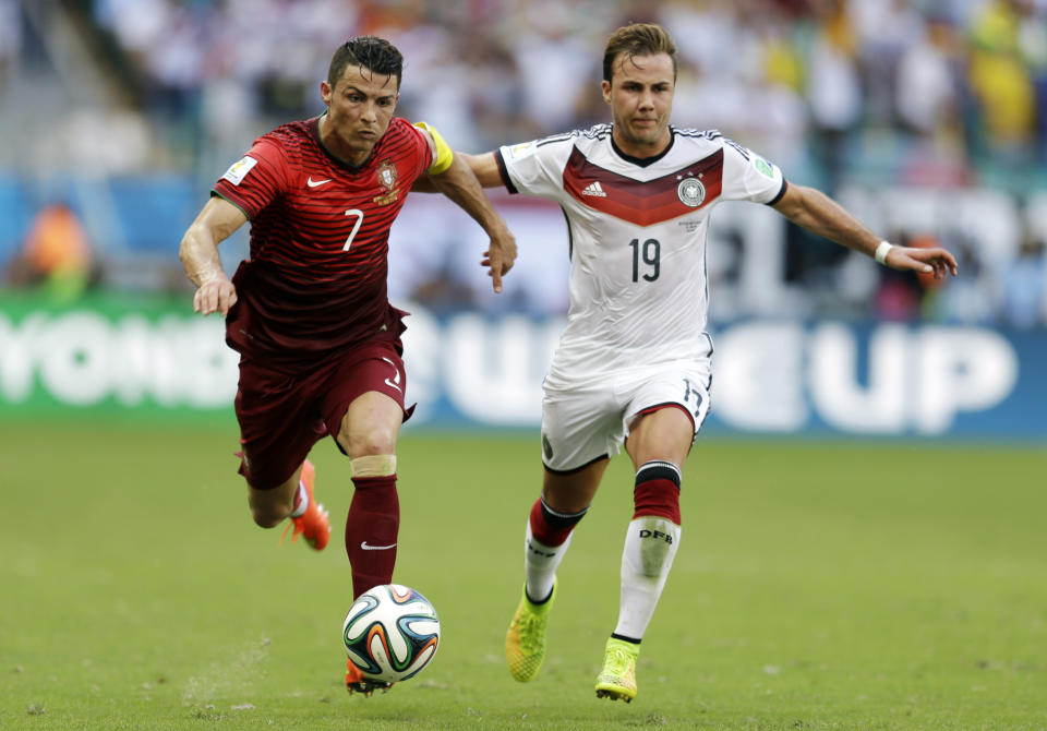 FILE - Germany's Mario Goetze (19) pushes off Portugal's Cristiano Ronaldo (7) during the group G World Cup soccer match between Germany and Portugal at the Arena Fonte Nova in Salvador, Brazil, Monday, June 16, 2014. (AP Photo/Natacha Pisarenko, File)