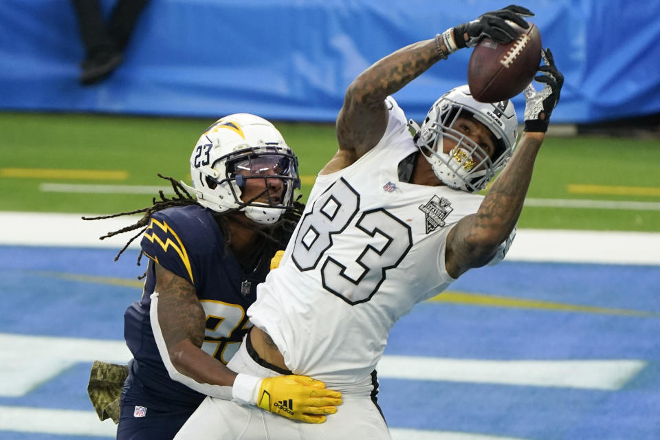 Las Vegas Raiders tight end Darren Waller (83) hauls in a touchdown pass as Los Angeles Chargers strong safety Rayshawn Jenkins defends second half of an NFL football game Sunday, Nov. 8, 2020, in Inglewood, Calif. (AP Photo/Alex Gallardo)