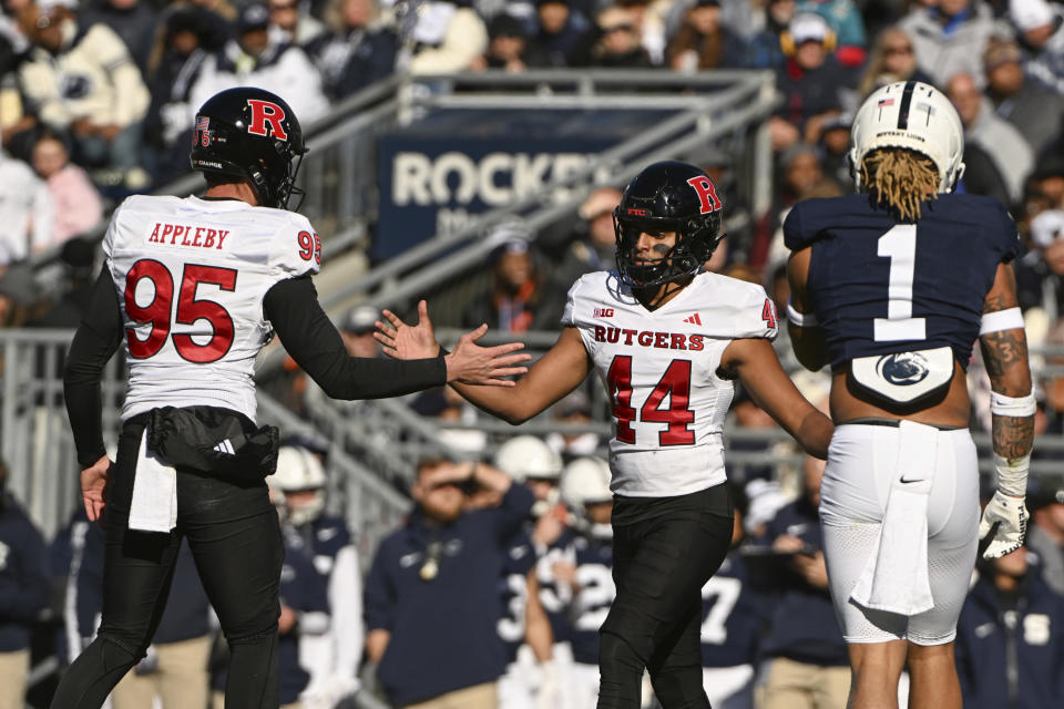 Rutgers kicker Jai Patel (44) celebrates with Flynn Appleby (95) after kicking a field goal against Penn State during the first half of an NCAA college football game, Saturday, Nov. 18, 2023, in State College, Pa. (AP Photo/Barry Reeger)