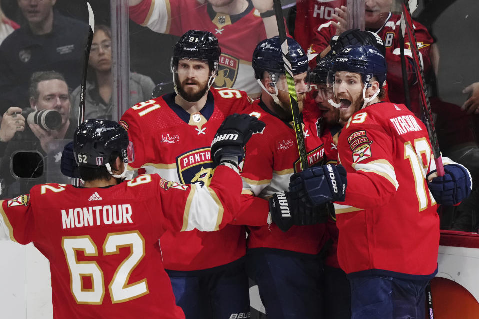 Florida Panthers' Evan Rodrigues, second from right, celebrates after his goal against the Edmonton Oilers with Brandon Montour (62), Oliver Ekman-Larsson (91), Sam Bennett (9) and Matthew Tkachuk (19) during the second period of Game 1 of the NHL hockey Stanley Cup Finals in Sunrise, Fla., Saturday, June 8, 2024. (Nathan Denette/The Canadian Press via AP)