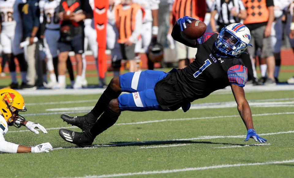 Hutchinson Blue Dragons receiver Cortez Braham stretches after making a catch in the KJCCC first-round playoff game against the Highland Scotties Sunday, Nov. 7, 2021 at Gowans Stadium.