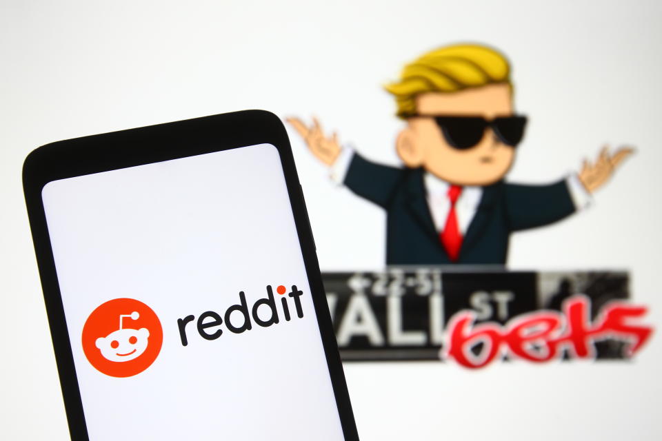 Reddit logo on a phone screen in front of WallStreetBets logo of a subreddit where participants discuss stock and options trading. Photo: Pavlo Gonchar/SOPA/LightRocket via Getty Images