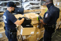 CBP officers in Atlanta inspect apparel suspected to be made with cotton harvested by forced labor in China's Xinjiang Region, August 2021. (U.S. Customs and Border Protection)