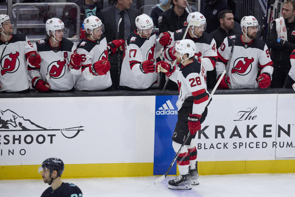 New Jersey Devils defenseman Damon Severson (28) is congratulated after scoring against the Seattle Kraken during the second period of an NHL hockey game, Thursday, Jan. 19, 2023, in Seattle. (AP Photo/John Froschauer)