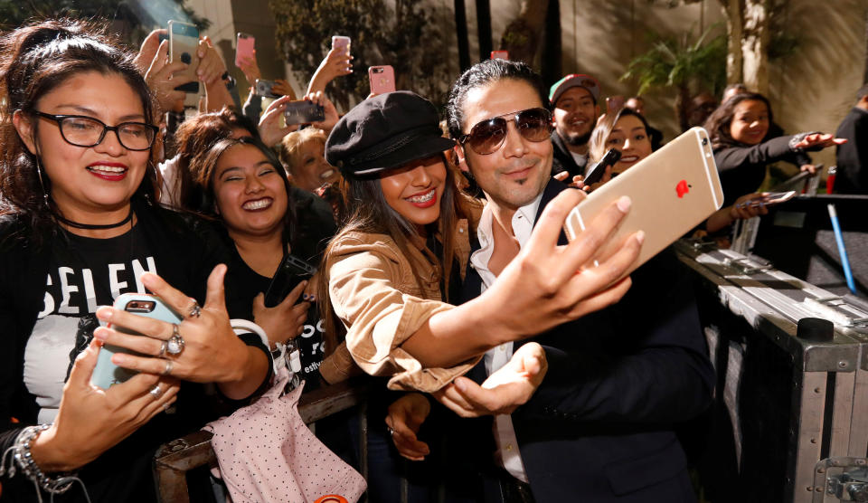 Chris Perez poses with fans after unveiling the star of late singer Selena Quintanilla-Perez on the Hollywood Walk of Fame in Los Angeles, California, U.S., November 3, 2017. REUTERS/Mario Anzuoni