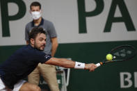 Switzerland's Stan Wawrinka plays a shot against Germany's Dominik Koepfer in the second round match of the French Open tennis tournament at the Roland Garros stadium in Paris, France, Wednesday, Sept. 30, 2020. (AP Photo/Alessandra Tarantino)