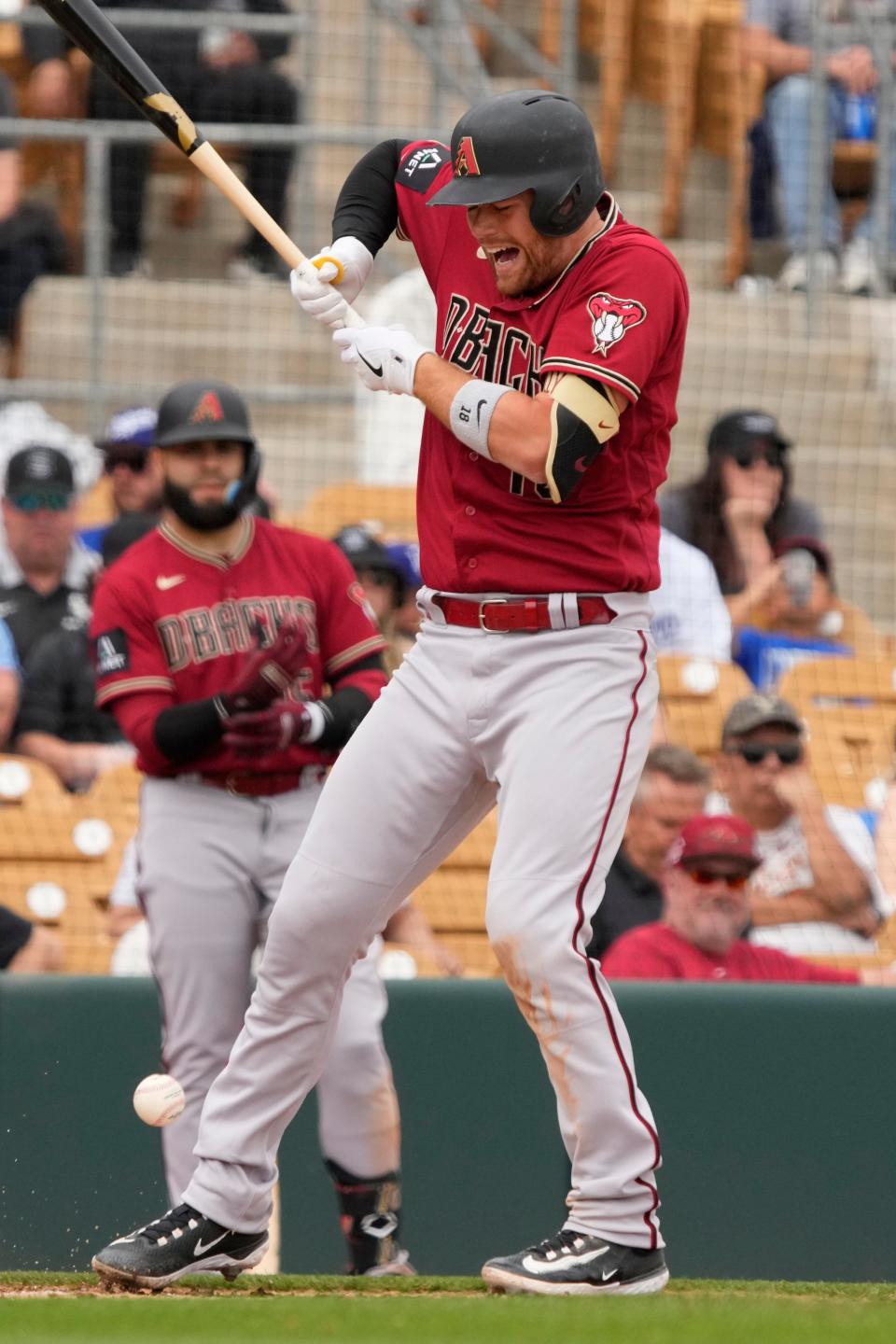 Arizona Diamondbacks catcher Carson Kelly (18) reacts after getting hit in the hand against the Chicago White Sox in the fourth inning at Camelback Ranch-Glendale in Phoenix on March 20, 2023.