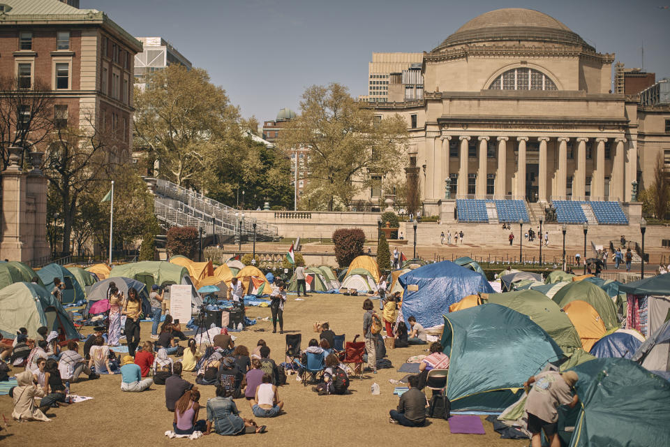 People listen to a speaker at a pro-Palestinian encampment, advocating for financial disclosure and divestment from all companies tied to Israel and calling for a permanent cease-fire in Gaza, inside the campus of Columbia University, Sunday, April 28, 2024, in New York. (AP Photo/Andres Kudacki)