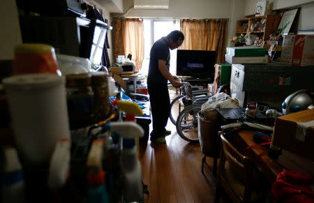 Akihiro Karube, 53, who lives with his widowed 84-year-old dad, is pictured at his public housing in Hino, suburb of Tokyo, Japan, February 23, 2017. REUTERS/Toru Hanai