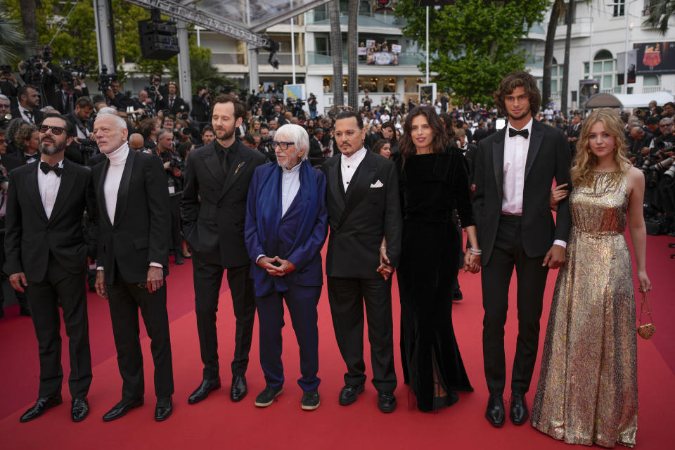 Melvil Poupaud, from left, Pascal Greggory, Benjamin Lavernhe, Pierre Richard, Johnny Depp, director Maiwenn, Diego Le Fur, and Pauline Pollmann pose for photographers upon arrival at the opening ceremony and the premiere of the film 'Jeanne du Barry' at the 76th international film festival, Cannes, southern France, Tuesday, May 16, 2023. (AP Photo/Daniel Cole)
