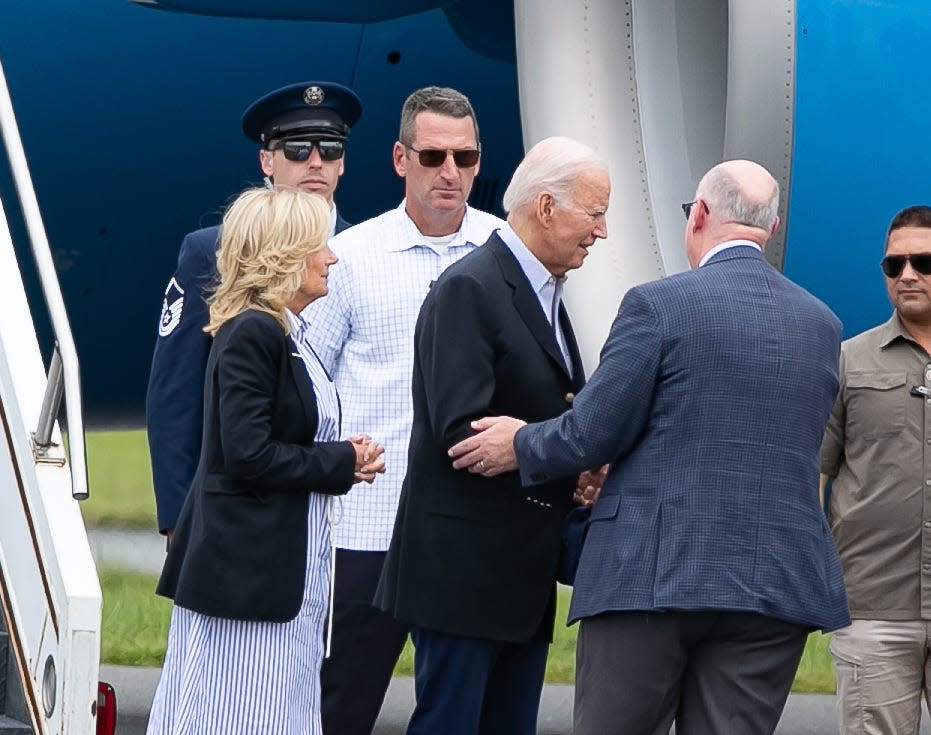 President Joe Biden, center, and first lady Jill Biden are greeted by Gainesville Mayor Harvey Ward, after the Bidens arrived at Gainesville Regional Airport in Gainesville on Saturday (Sept. 2, 2023.) The Bidens later boarded a presidential helicopter to tour Hurricane Idalia devastation around Live Oak.