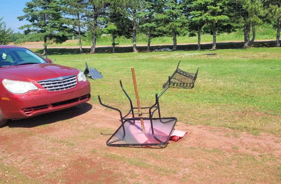 Patio furniture from a home in Campbellton, Prince Edward Island, was blown onto the lawn after a microburst hit the area. 