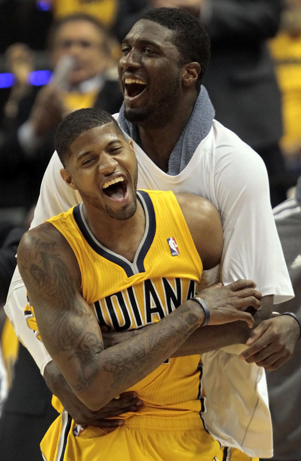 Indiana Pacers forward Paul George, front, and center Roy Hibbert react to a basket in the second half during Game 7 of a first-round NBA basketball playoff series against the Atlanta Hawks in Indianapolis, Saturday, May 3, 2014. The Pacers won 92-80. (AP Photo/AJ Mast)