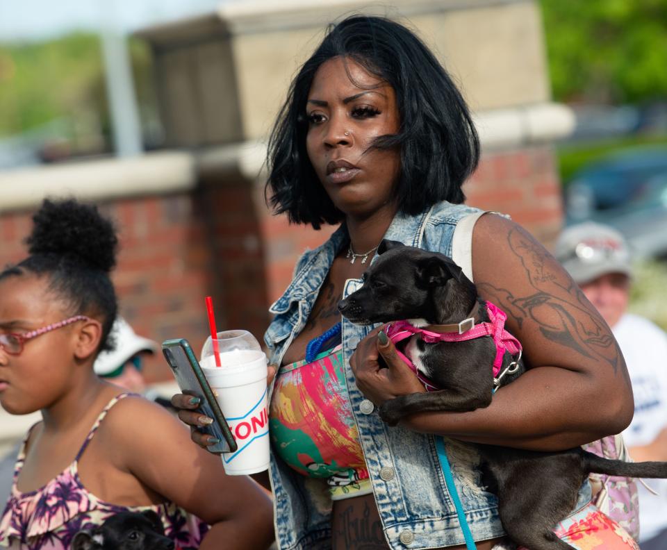 Maria Simms holds her dog, Ginger, as they arrive for the inaugural Puppy Palooza event at Midtown Village Friday, April 15, 2022. The event benefits the West Alabama Humane Society. Gary Cosby Jr./Tuscaloosa News  