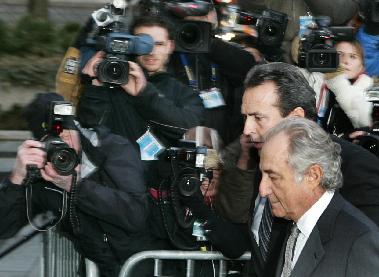 Accused swindler Bernard Madoff (bottom) enters the Manhattan federal court house in New York March 12, 2009. Madoff, accused of running the biggest fraud in Wall Street history, is expected to plead guilty on Thursday in what is shaping up to be a courtroom drama featuring denunciations by investors and a renewed push by prosecutors to jail him immediately.   REUTERS/Shannon Stapleton   (UNITED STATES BUSINESS CONFLICT SOCIETY)