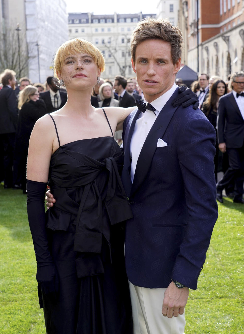 Jessie Buckley, left, and Eddie Redmayne arrive for the Laurence Olivier Awards at the Royal Albert Hall, London, Sunday April 10, 2022. (Ian West/PA via AP)