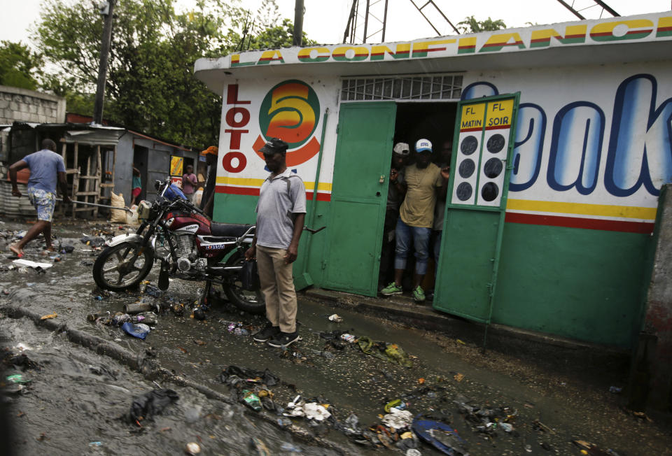 Debris litters a street caused by a flood of water brought on by heavy rains that fell over Port-au-Prince, Haiti, Friday, July 9, 2021, two days after Haitian President Jovenel Moise was assassinated in his home. (AP Photo/Fernando Llano)