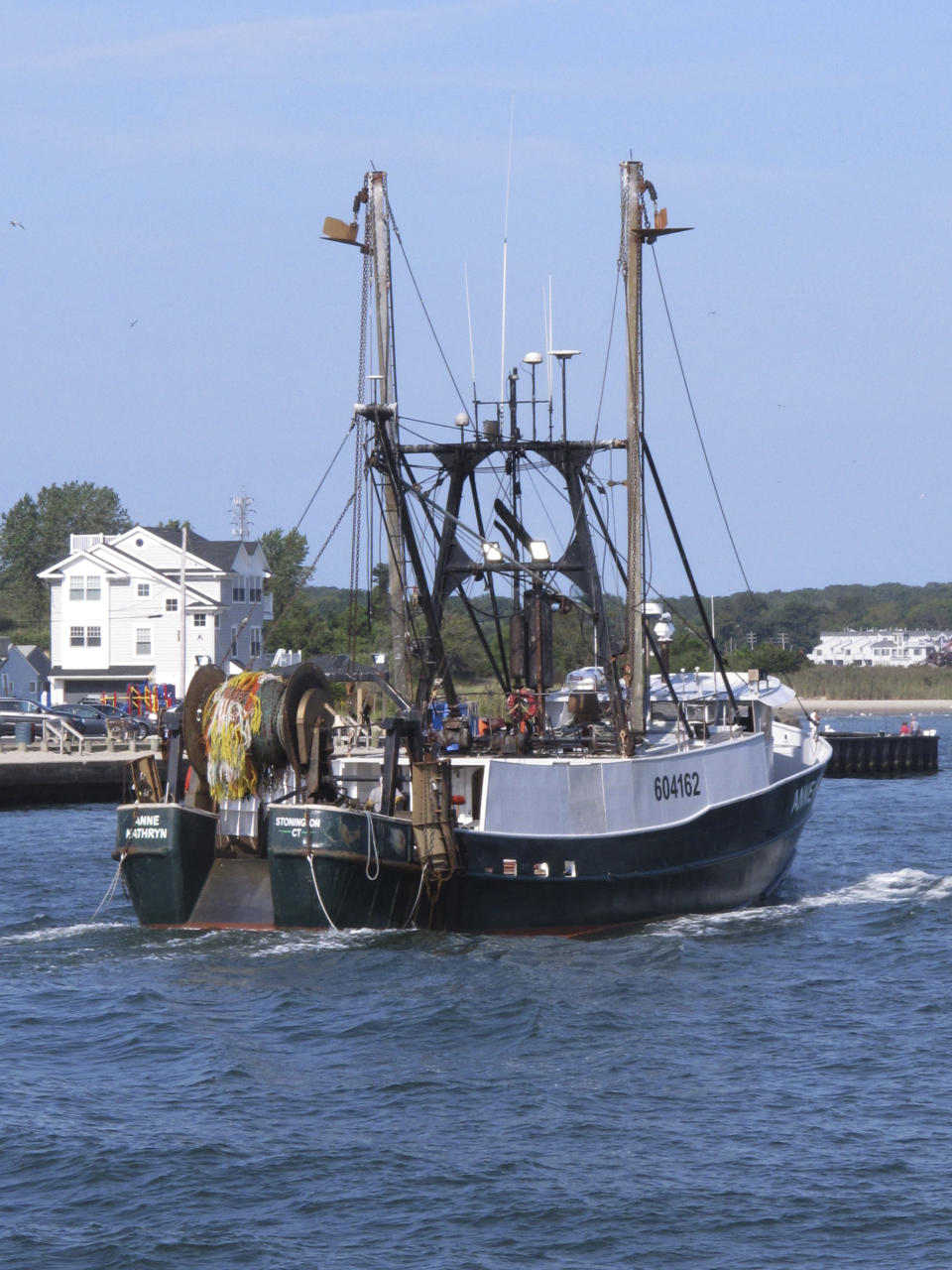 A fishing boat enters the Manasquan Inlet in Manasquan N.J. on Sept. 11, 2019 after returning from the ocean. A report issued March 29, 2023 by two federal marine science agencies and the commercial fishing industry highlighted several potential negative aspects of offshore wind energy development on the fishing industry and called for additional research. (AP Photo/Wayne Parry)