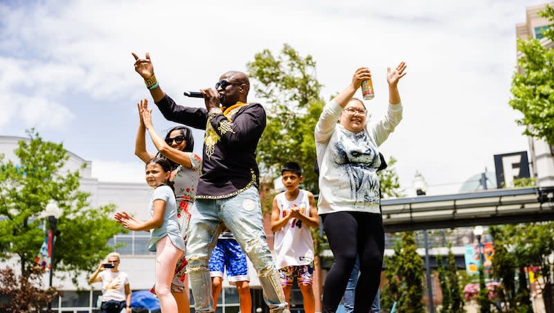 Alex Boye performs with onlookers during the Juneteenth celebration at The Gateway in Salt Lake City on June 19, 2023.