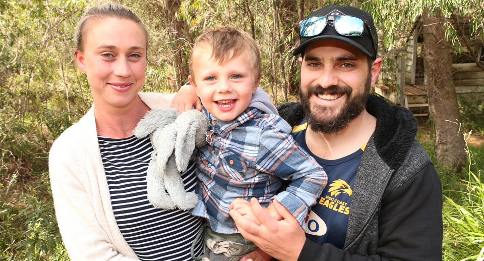 James is pictured with his mum and dad after being found alive and well in dense bushland. Source: Jackson Flindell
