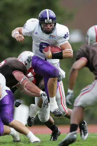 Holy Cross quarterback Dominic Randolph eludes the defensive pressure of Brown University's Peter Hughes during a 2009 game.