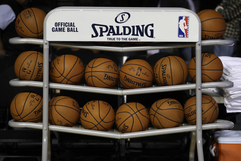 FILE - In this Dec. 6, 2017, file photo, basketballs sit in a rack on the court during a training session by the Brooklyn Nets at the Mexico City Arena in Mexico City. The four major pro sports leagues and the NCAA think that expanding legal betting will lead to more game-fixing. The architects of New Jersey’s successful legal challenge to the sports gambling ban say those fears are overstated and that bringing sports betting out of the shadows will make it easier to detect illegal activity. (AP Photo/Rebecca Blackwell, File)