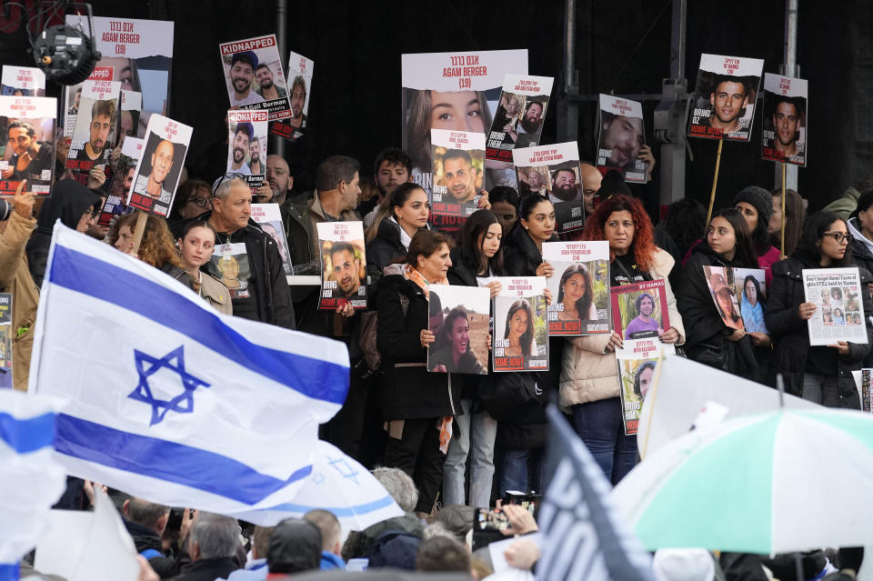 Families of hostages and former hostages hold images on a podium at a protest near the International Crime Court at The Hague, Netherlands, during a press conference of representatives of families of hostages from the Oct. 7 cross-border attack by Hamas on Israel, Wednesday, Feb. 14, 2024. The Hostages Families Forum together with the Raoul Wallenberg Center for Human Rights is submitting a comprehensive complaint to the International Criminal Court on behalf of released hostages and families of hostages, including the issuance of arrest warrants for Hamas leaders on war crimes allegations including taking hostages, enforced disappearances, sexual violence and torture. (AP Photo/Martin Meissner)