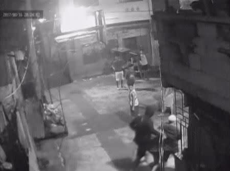 CCTV footage appearing to show Kian Loyd Delos Santos being dragged by plain-clothed police past a basketball court in Caloocan City Barangay, Philippines August 16, 2017 in this still image taken from video. CALOOCAN CITY BARANGAY 160/Handout via Reuters TV