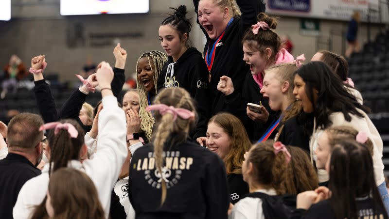 Wasatch High School celebrates a first place win during the 5A Girls Wrestling State Championships at the UCCU Center in Orem on Thursday, Feb. 15, 2024.
