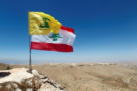 Lebanese and Hezbollag flags are seen in Juroud Arsal, Syria-Lebanon border, July 25, 2017. REUTERS/Mohamed Azakir