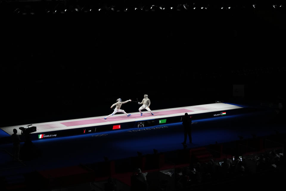 Aron Szilagyi of Hungary, right, and Luigi Samele of Italy compete in the men's individual final Sabre competition at the 2020 Summer Olympics, Saturday, July 24, 2021, in Chiba, Japan. (AP Photo/Hassan Ammar)