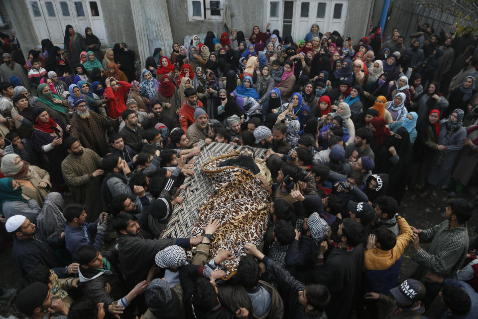 Kashmiri villagers carry the body of killed rebel Khalid Farooq, during his funeral in Shopian village, south of Srinagar, Indian controlled Kashmir, Sunday, Nov. 25, 2018. Six rebels and an army soldier were killed in a gunbattle in Indian-controlled Kashmir on Sunday, officials said, sparking violent protests by residents seeking an end to Indian rule over the disputed region and leaving a teenage boy dead and 20 people injured. (AP Photo/Mukhtar Khan)