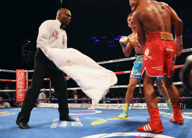 Trainer Dominic Ingle throws in the towel to ask referee Marlon B. Wright to stop the bout between Gennady Golovkin and Kell Brook (red shorts). Golovkin won by fifth-round TKO. (Getty Images)