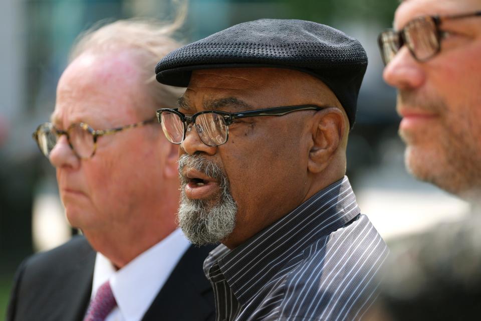Glynn Simmons, recently released after 48 years in prison, is flanked by attorneys John Coyle, left, and Joe Norwood, right, during a news conference Wednesday outside the Oklahoma County Courthouse.