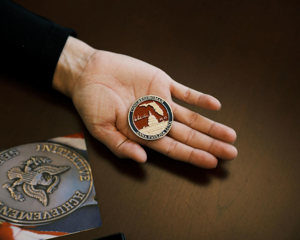 Luna holds a coin emblazoned with her name.<span class="copyright">Zack Wittman for TIME</span>