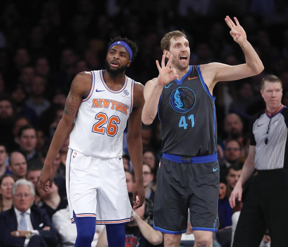 Dallas Mavericks forward Dirk Nowitzki (41) signals to his bench with New York Knicks center Mitchell Robinson (26) awaiting the an official's call during the first half of an NBA basketball game, Wednesday, Jan. 30, 2019, in New York. (AP Photo/Kathy Willens)