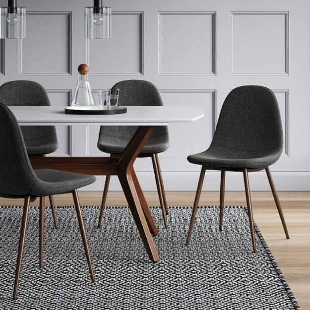 the gray chairs around a dining table