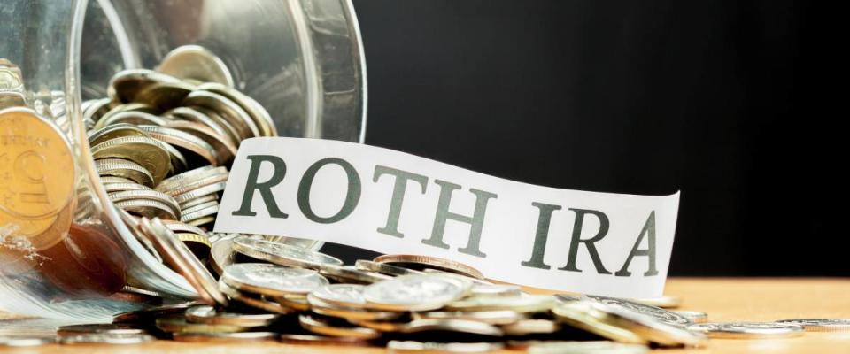 Roth IRA coins in a jar, saving for retirement concept