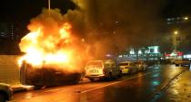 A blazing police car lies flipped on its side after rioters went on a rampage in Singapore's Little India district late on December 8