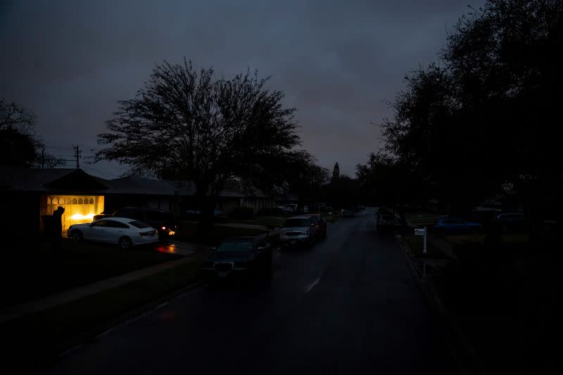 FILE PHOTO: A car idles in a driveway on Jordan Drive, a street with no power in the early morning in Corpus Christi