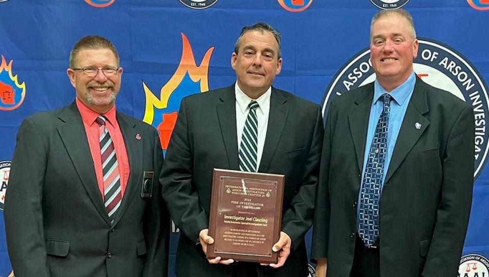 Michael Geissler, Battalion Chief / Lead Fire Investigator of the Grand Chute Fire Department (left), and Jason F. Knecht, Fire Inspector at Eau Claire Fire & Rescue (right) present the Fire Investigator of the Year Award from The Wisconsin Chapter of the International Association of Arson Investigators to Joel Clausing, Special Investigator at Acuity Insurance (center).