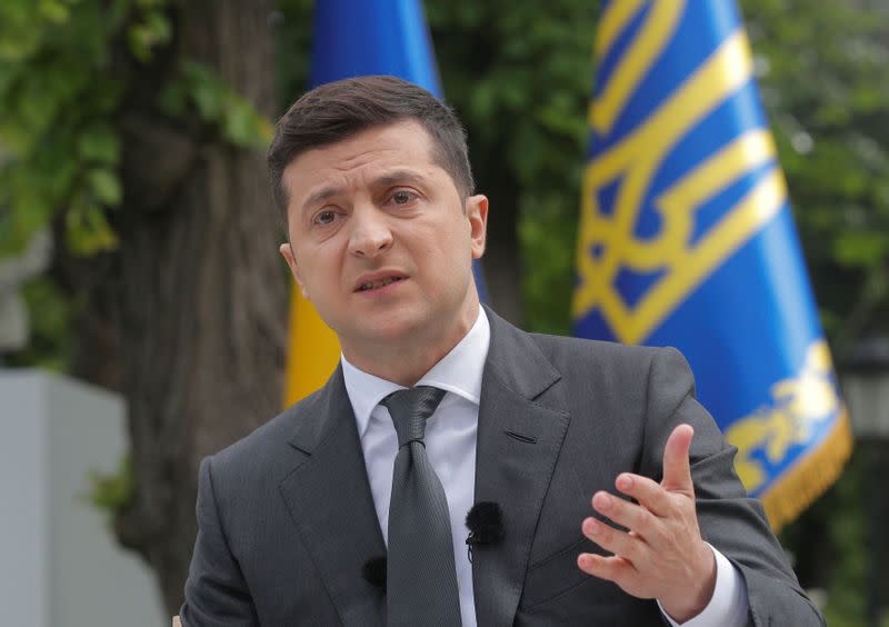 FILE PHOTO: Ukrainian President Volodymyr Zelenskiy gestures during an open-air news conference in Kiev