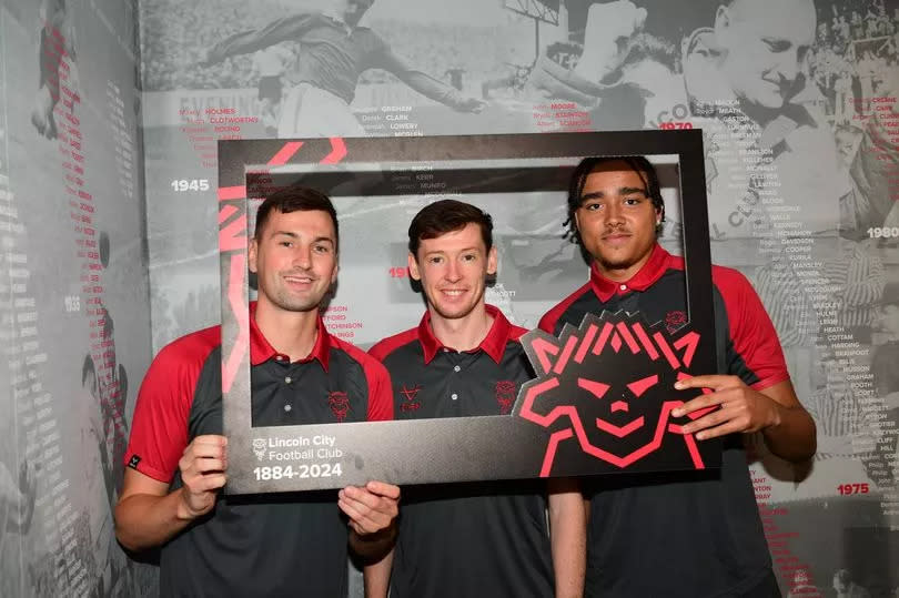 Lincoln City players (L-R) Paudie O’Connor, Conor McGrandles and Jovon Makama pose at an event to mark the football club’s 140th birthday