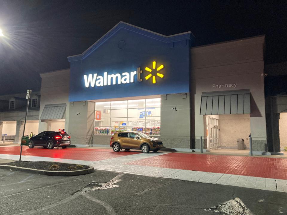 The exterior of a Walmart at nighttime.